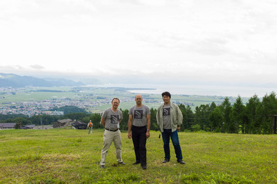 Safecast’s Pieter, Joe, and Hideki Washiyama with Lake Inawashiro at their back. 